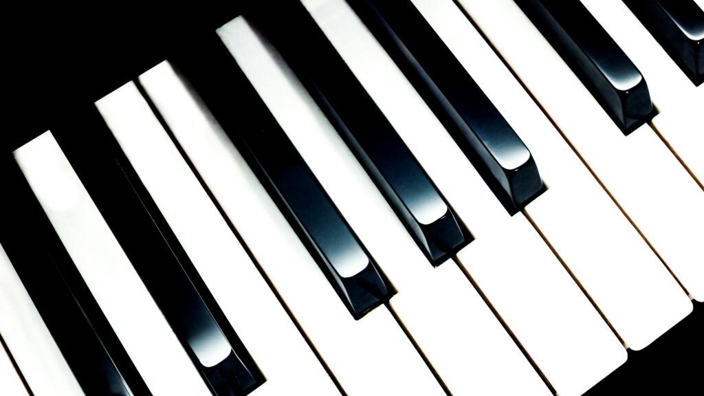 Detailed close-up image of piano keys, showcasing classic black and white contrast.