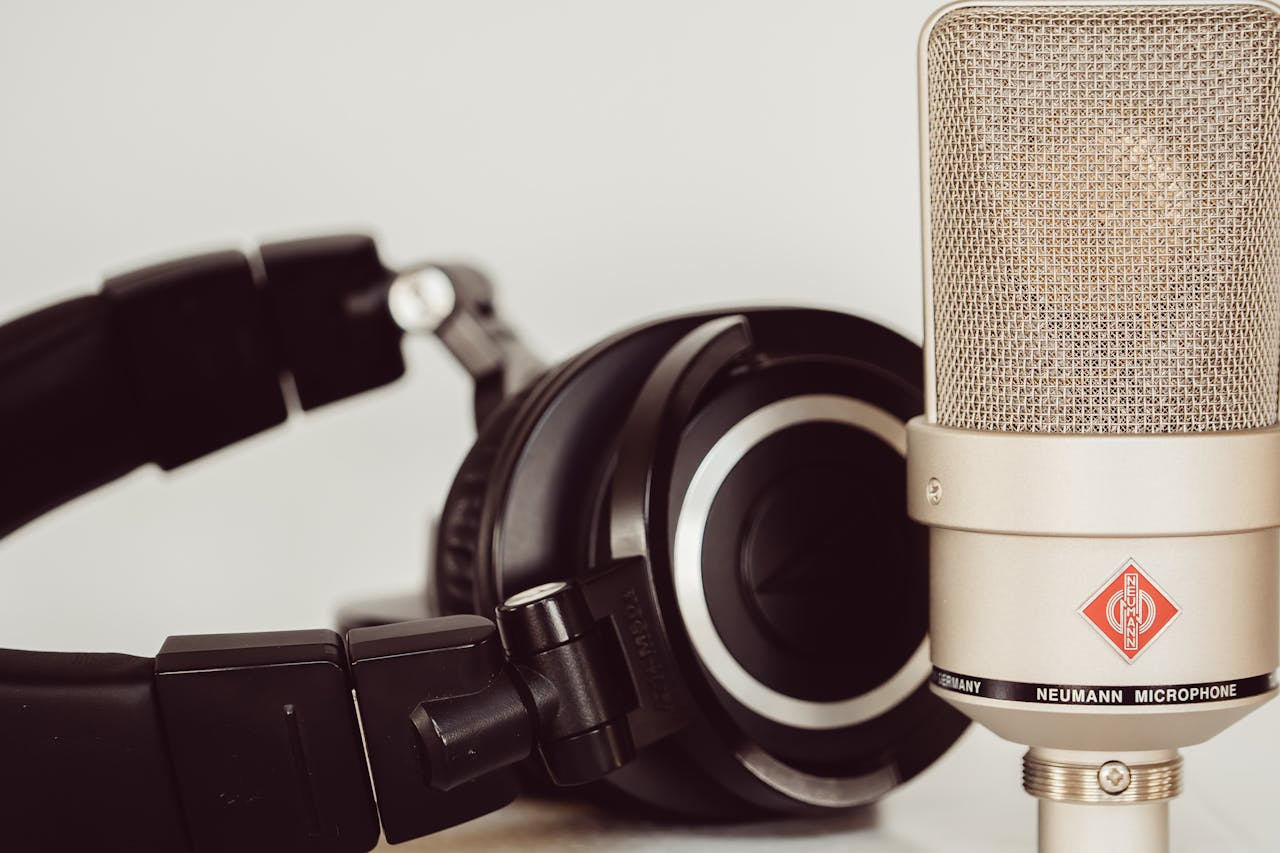 Close-up of a high-quality studio microphone paired with headphones, essential for recording.